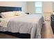 Comfortable bedroom features a plush bed, neutral decor, and natural light from the window at 19278 Roseate Dr, Lutz, FL 33558