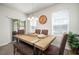 Cozy dining area with a unique wood table, bench seating, and backyard views at 19278 Roseate Dr, Lutz, FL 33558