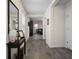 Inviting home hallway with wood-look floors and decoratively appointed console table at 19278 Roseate Dr, Lutz, FL 33558