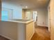 Upstairs hallway with neutral walls and carpet leading to various rooms at 19278 Roseate Dr, Lutz, FL 33558
