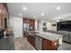 Open concept kitchen with stainless appliances, granite countertops, and a view to the living space at 19278 Roseate Dr, Lutz, FL 33558