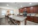 Open kitchen with a large island, granite countertops, and stainless steel appliances at 19278 Roseate Dr, Lutz, FL 33558