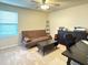 Multi-purpose room set up as a home office with a futon, desk, and ample storage at 19278 Roseate Dr, Lutz, FL 33558