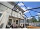 Enclosed patio featuring hot tub, ceiling fans, and a cozy seating area creating the perfect spot for relaxation at 19278 Roseate Dr, Lutz, FL 33558