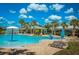 Resort-style pool featuring a splash fountain, sun loungers and shaded cabanas, creating an oasis for residents at 19278 Roseate Dr, Lutz, FL 33558