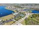A neighborhood view featuring a lake, community pool and tennis court and manicured lawns at 19796 Long Lake Ranch Blvd, Lutz, FL 33558