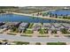 Beautiful aerial view of homes by a serene pond, showcasing the community's peaceful setting and well-maintained landscaping at 19796 Long Lake Ranch Blvd, Lutz, FL 33558