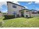 Expansive backyard featuring a covered patio, well-maintained lawn, and privacy fencing for ultimate relaxation at 19796 Long Lake Ranch Blvd, Lutz, FL 33558