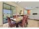 Open-concept dining room with outdoor access and views into the living room with fireplace at 19796 Long Lake Ranch Blvd, Lutz, FL 33558