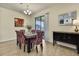 Cozy dining room with elegant chandelier, modern mirror, and sliding door to outdoor patio at 19796 Long Lake Ranch Blvd, Lutz, FL 33558
