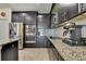 The kitchen features stainless steel appliances, granite counters, and ample cabinetry at 19796 Long Lake Ranch Blvd, Lutz, FL 33558