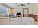 Bright living room with tile accent wall, a ceiling fan and large windows at 19796 Long Lake Ranch Blvd, Lutz, FL 33558