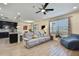 Open-concept living room flows to the kitchen, offers modern ceiling fan and lots of natural light at 19796 Long Lake Ranch Blvd, Lutz, FL 33558