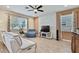 Bright living room with tile accent wall, a ceiling fan and large windows at 19796 Long Lake Ranch Blvd, Lutz, FL 33558