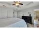 Bright main bedroom featuring tray ceiling, closet, and modern dresser with decorative flowers at 19796 Long Lake Ranch Blvd, Lutz, FL 33558