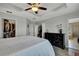 Elegant main bedroom featuring tray ceiling, closet, and modern dresser with decorative flowers at 19796 Long Lake Ranch Blvd, Lutz, FL 33558