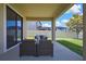 Covered patio with outdoor seating provides a cozy space for relaxation with views of the backyard at 19796 Long Lake Ranch Blvd, Lutz, FL 33558