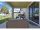 Covered patio with outdoor seating and sliding glass doors to seamlessly blend indoor and outdoor living at 19796 Long Lake Ranch Blvd, Lutz, FL 33558