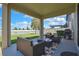 Relaxing covered patio featuring comfortable seating, a view of the fenced yard, and outdoor living at its finest at 19796 Long Lake Ranch Blvd, Lutz, FL 33558