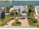 Beautiful waterfront home featuring lush landscaping, a circular driveway, and a spacious garage at 213 Harrison Ave, Belleair Beach, FL 33786