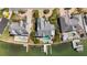 Aerial shot of a waterfront neighborhood, highlighting pools, docks, lush landscaping, and backyard living spaces at 213 Harrison Ave, Belleair Beach, FL 33786
