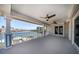Spacious waterfront balcony with white columns and railing overlooking the beautiful canal and ceiling fans for added comfort at 213 Harrison Ave, Belleair Beach, FL 33786