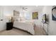 Cozy bedroom with natural light, carpet, and art pieces that bring a vibrant pop of color to the room at 213 Harrison Ave, Belleair Beach, FL 33786