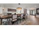 Spacious dining room features modern chandelier lighting, a large table with seating, and stylish decor at 213 Harrison Ave, Belleair Beach, FL 33786