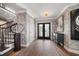 Elegant foyer with stylish wallpaper, hardwood floors, and staircase at 213 Harrison Ave, Belleair Beach, FL 33786