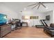 Spacious home office equipped with multiple monitors, hardwood floors, fan, and a treadmill for convenient workouts at 213 Harrison Ave, Belleair Beach, FL 33786