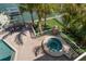 Backyard view featuring a hot tub, putting green, and outdoor dining with nearby boat lift at 213 Harrison Ave, Belleair Beach, FL 33786