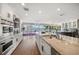 Spacious kitchen with a large island, stainless steel appliances, and water views at 213 Harrison Ave, Belleair Beach, FL 33786