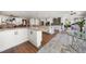 Open kitchen featuring white cabinets, granite countertops, and stainless steel appliances at 213 Harrison Ave, Belleair Beach, FL 33786