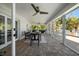Covered lanai featuring brick flooring and outdoor dining area with water views at 213 Harrison Ave, Belleair Beach, FL 33786