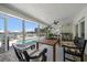 Covered lanai featuring water views, outdoor seating, and access to pool at 213 Harrison Ave, Belleair Beach, FL 33786