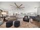 Spacious living room featuring wood floors, plush seating, and wet bar with waterfront views at 213 Harrison Ave, Belleair Beach, FL 33786
