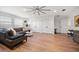 An expansive living room boasts hardwood floors, a gray sofa, and recessed lighting, with multiple storage closets at 213 Harrison Ave, Belleair Beach, FL 33786