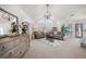Spacious living room with high ceilings, elegant chandelier, and comfortable seating at 213 Harrison Ave, Belleair Beach, FL 33786