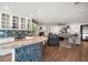 Open-concept living room showcasing wood floors, fireplace, and a wet bar at 213 Harrison Ave, Belleair Beach, FL 33786
