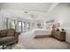 Bright main bedroom with balcony access, ceiling fan, and soothing color palette at 213 Harrison Ave, Belleair Beach, FL 33786
