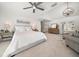 Bright main bedroom featuring a seating area, ceiling fan, and balcony access at 213 Harrison Ave, Belleair Beach, FL 33786