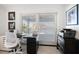 Bright office featuring water views from a large window, neutral decor, and sleek black furniture at 213 Harrison Ave, Belleair Beach, FL 33786
