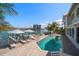 Waterfront home with a beautiful pool and hot tub overlooking the canal and a dock with a boat lift at 213 Harrison Ave, Belleair Beach, FL 33786