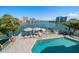 Waterfront pool and patio with lounge chairs and city views; perfect for outdoor living at 213 Harrison Ave, Belleair Beach, FL 33786