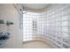 Modern shower featuring glass block curved walls, tile surround, and chrome fixtures for a luxurious bathing experience at 213 Harrison Ave, Belleair Beach, FL 33786