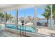 Waterfront view from the living room showcasing a swimming pool and dock at 213 Harrison Ave, Belleair Beach, FL 33786