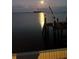 Moonlit waterfront view with dock and boat lift at 2172 Harbor View Dr, Dunedin, FL 34698