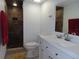 Bathroom with tiled shower, modern vanity, and decorative accents at 224 Cypress Ln # 224, Oldsmar, FL 34677