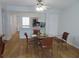 Dining area with hardwood floors and modern furnishings next to an open concept kitchen at 224 Cypress Ln # 224, Oldsmar, FL 34677