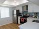 Modern kitchen with stainless steel appliances, including a refrigerator, range, and white cabinetry at 224 Cypress Ln # 224, Oldsmar, FL 34677